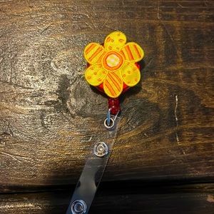 Orange and yellow flower badge reel